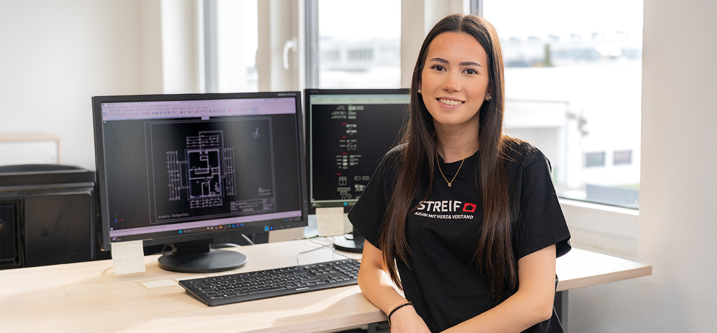 Mitarbeiter STREIF Auszubildende am Arbeitsplatz vor Monitoren mit technischem Bauplan im Büro